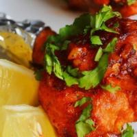 Chicken Lollipop · Deep fried chicken wings tossed in spicy garlic sauce.