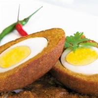 Egg Bonda · Wedges of billed eggs coated with spices flour batter and fried.