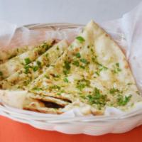 Chili Naan · White flour dough mixed with milk and butter, baked in a tandoor clay oven.