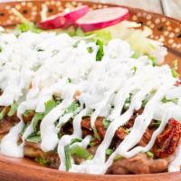 Huaraches · Handmade oval corn dough huarache with sauce and meat of your choice beans lettuce,sour crea...