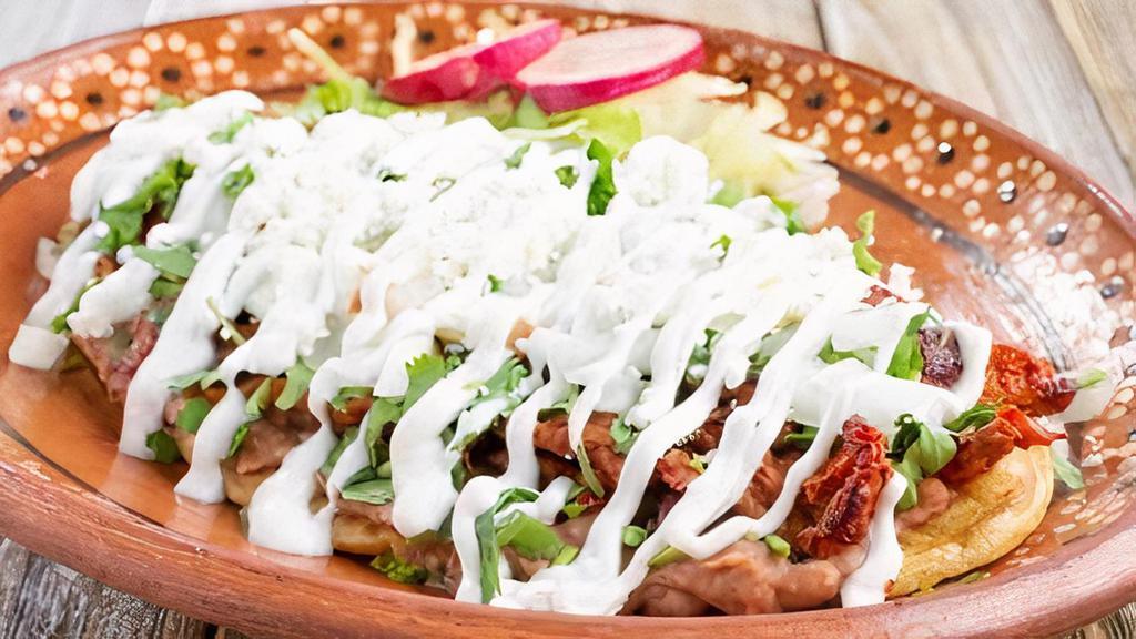 Huaraches · Handmade oval corn dough huarache with sauce and meat of your choice beans lettuce,sour cream, queso fresco.