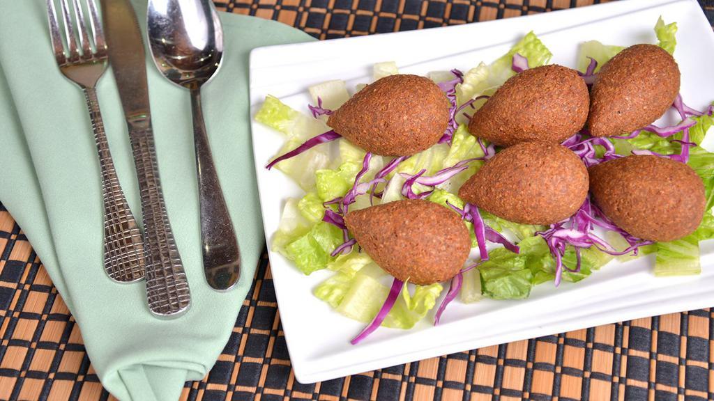 Fried Kibbeh · Six pieces fried pieces of ground meat mixed with cracked wheat and stuff ed with sautéed ground meat, onion, walnut, and special spices.