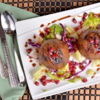 Char-Grilled Kibbeh · Two pieces char-grilled pieces of ground meat mixed with lamb fat and cracked wheat and stuf...