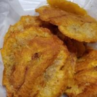 Tostones · Lightly fried and salted slices of plantain drizzled with garlic oil.