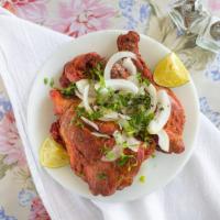 Tandoori Chicken · Tender baked chicken marinated in yogurt lemon juice, chilli pepper, ginger, garlic and othe...