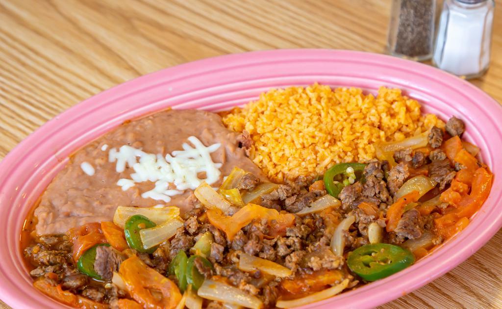Bistec A La Mexicana · Steak simmered in tomato, fresh jalapenos, onions sauce choice of flour or corn tortillas