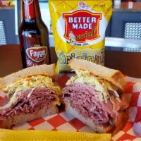 Corned Beef Deluxe · Sy Ginsberg's corned beef with Swiss, coleslaw and Russian dressing on rye.
