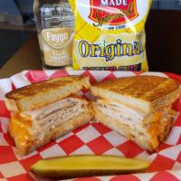 Turkey In The Straw · Roasted turkey breast with Swiss cheese, coleslaw and Russian dressing on grilled rye.