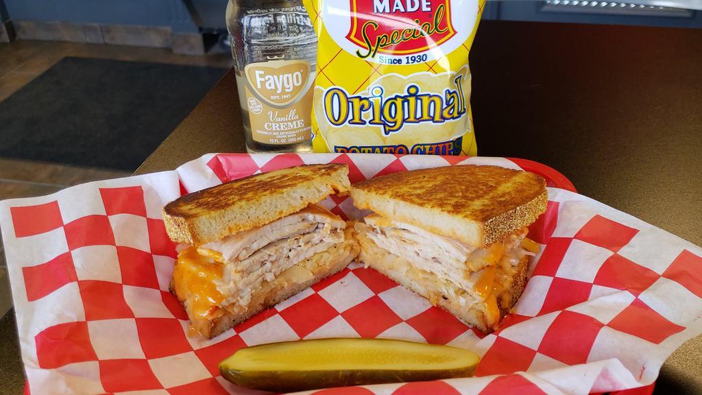 Turkey In The Straw · Roasted turkey breast with Swiss cheese, coleslaw and Russian dressing on grilled rye.