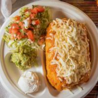 Chimichanga · Fried flour tortilla stuffed with your choice of meats, rice, beans, and topped with rancher...