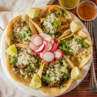 Tacos Dorados · Order of 3, Crispy flautas. Chicken or potatoes over lettuce and topped with sour cream, gra...
