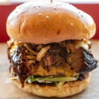 Aljoom Burger · Grilled black Angus beef patty topped with smoked beef brisket with lettuce, crispy fried on...