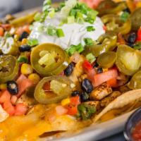 Macho Nachos · Beef or shredded chicken, sausage queso, cheddar and jack cheese, black bean salsa, tomatoes...