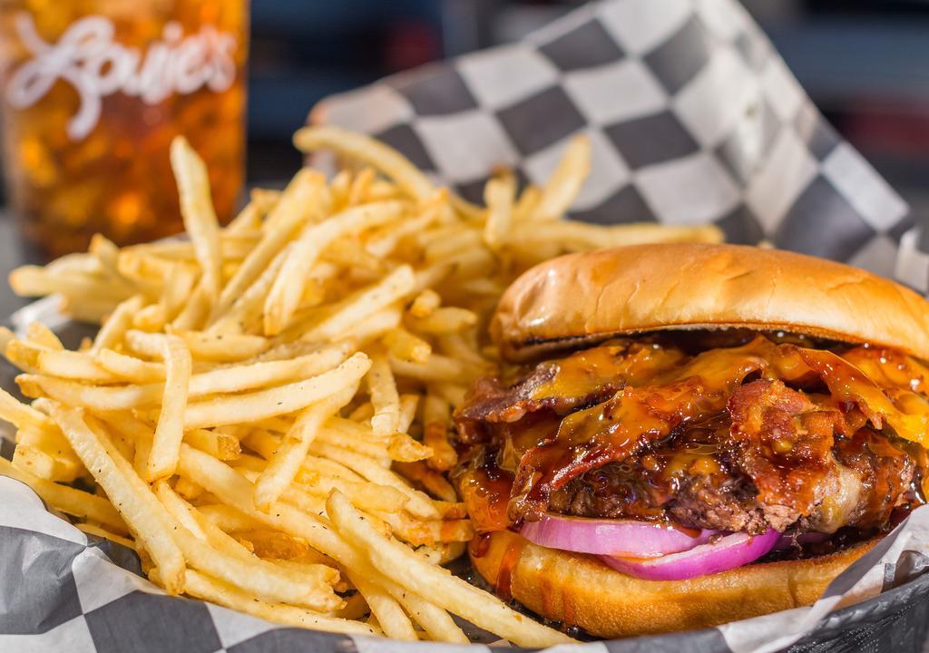Prohibition Burger · Bacon, hickory bourbon sauce, cheddar jack cheese, and red onion. Served with half pound of golden fries.