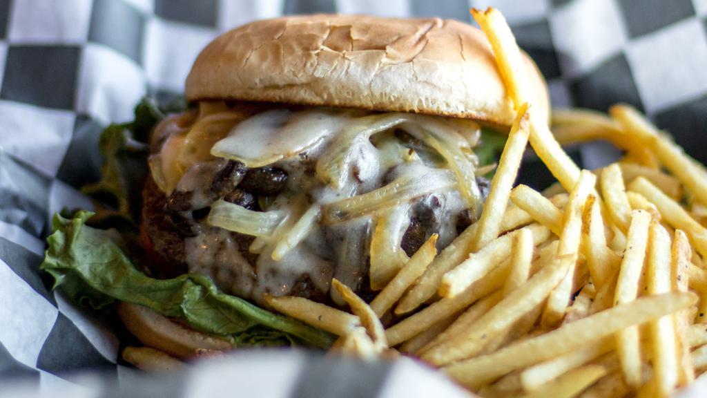 Louies Shroom & Swiss Burger · Mayo, lettuce, tomato, pickles, sauteed mushrooms, grilled onions, and Swiss cheese. Served with half a pound of golden fries.