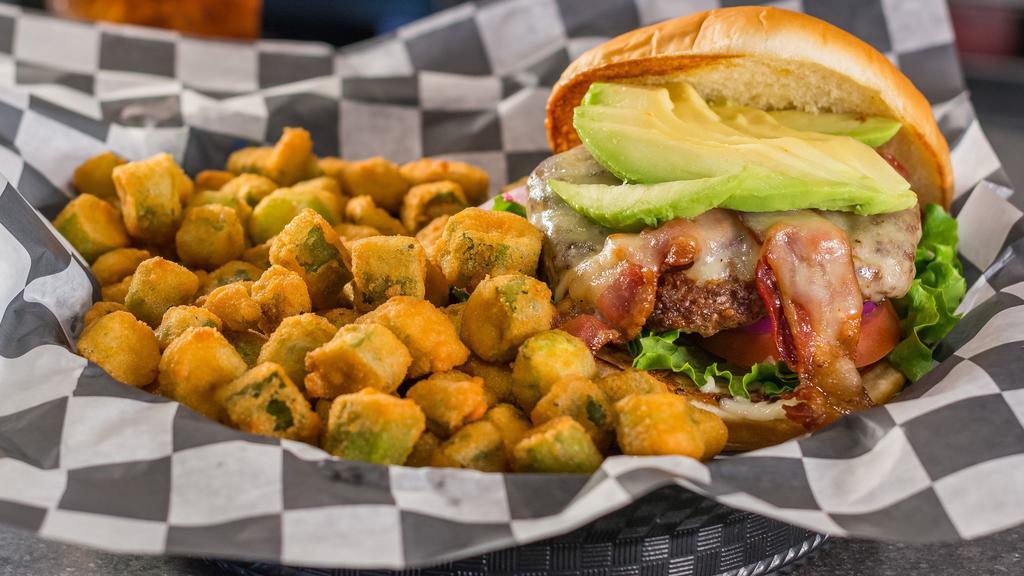 Avocado Burger · Bacon, mayo, lettuce, tomato, red onion, avocado, and Swiss cheese. Served with a half pound of golden fries.