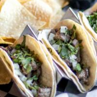 Side Street Taco · Corn tortillas, skirt steak, diced onions, cilantro, fresh lime, and side of spicy crema. Se...