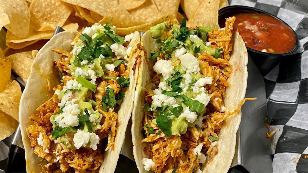 Tinga Tacos · Flour Tortillas, Shredded Tinga Chicken, Pinto Beans, Guacamole, Lettuce, Cilantro, Queso Fresco. Served with chips and salsa.