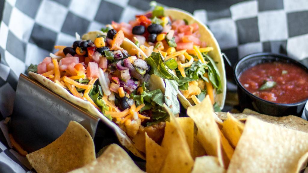 Fish Taco · Flour tortillas, beer battered fish, lettuce, tomato, cheddar Jack cheese, chipotle honey mustard, and black bean salsa. Served with chips and salsa.
