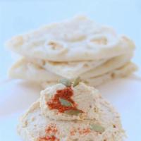 Hummus · A Mediterranean favorite topped with fresh diced tomatoes and kalamata olives served with wa...