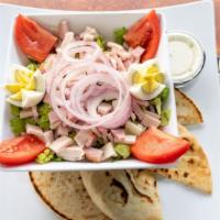 Chef Salad · Turkey, ham, swiss or American cheese, egg, and our house dressing tops crisp lettuce, serve...