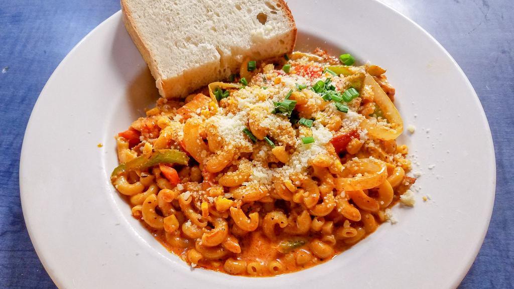 Creole Macaroni · Chicken, cajun sausage, peppers, onions, tomatoes, and corn tossed in a cajun cream sauce. Served with cuban bread.