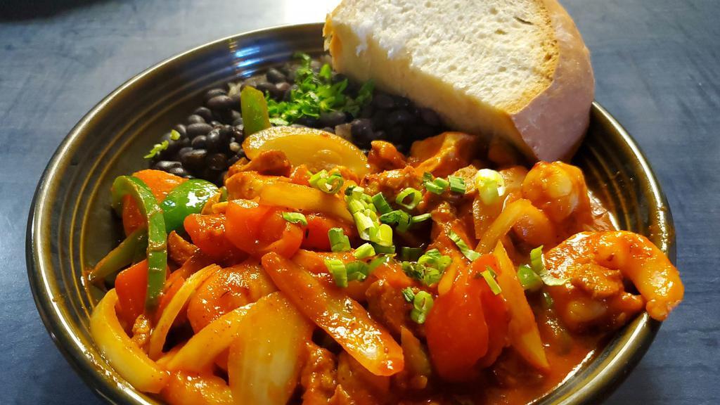 Cajun Jambalaya · Chicken,​ Cajun sausage, peppers, onion, tomatoes, garlic, spicy smoked chili sauce on steamed rice served with black beans and Cuban bread.