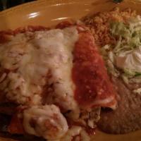 Tres Enchiladas · Chicken, beef or steak rolled in corn tortillas topped with spicy red sauce and melted chees...