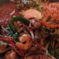 Chicken Fajitas · 9oz of chicken  with red, yellow & green peppers, rice, beans and guacamole.