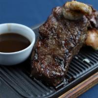 Ny Strip Steak & Shrimp · 12 oz Steak grilled to perfection and basted with Zip Sauce, complimented with 2 Prawns and ...