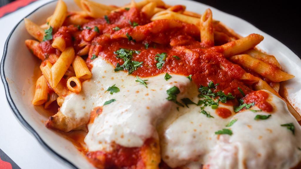Veal Parmigiana · Lightly breaded and baked with mozzarella, parmesan, marinara and served with a side of penne marinara.