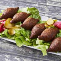 Fried Kibbee · 6 pieces. Football-shaped shells of cracked wheat stuffed with seasoned meat and pine nuts.
