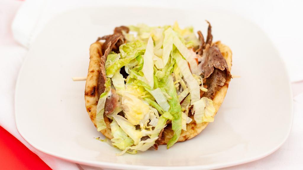 Gyro · Served with creamy garlic sauce or cucumber sauce, lettuce, tomatoes, and onions.
