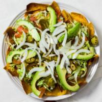 Botana · Corn chips with beans, Mexican sausage, cheese, lettuce, onions, avocado, and jalapeños.