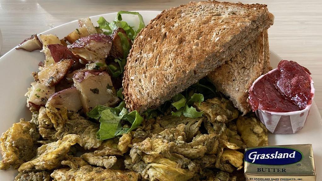 Pesto Scrambler · Housemade pesto mixed with your choice of eggs or tofu, served with breakfast potatoes and choice of bread.