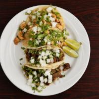 Tacos · Double corn soft tortilla with your choice of meat. comes with cilantro and onion to the sid...