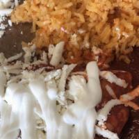 Two Enchiladas · Served with chicken or ground beef with rice, beans, onions, lettuce, sour cream, and queso ...
