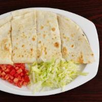 Quesadilla · Flour tortilla with a choice of meat and on the side of lettuce and tomatoes.