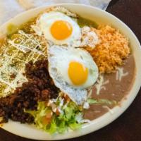 Chilaquiles · Fried corn tortillas cut in quarters smothered in red or green sauce, panela cheese, two egg...