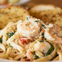 Shrimp Scampi · Spaghetti noodles cooked in a white wine and garlic butter sauce with shallots, parsley oven...