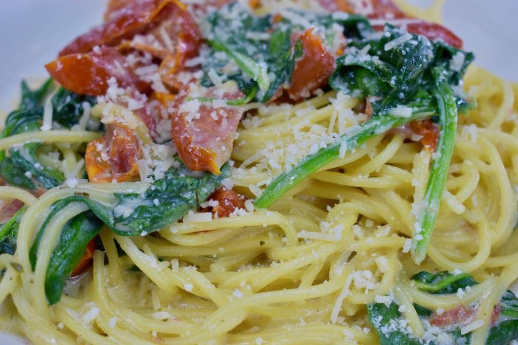 Florentine · Spinach, garlic and tomatoes sautéed in white wine cream sauce over spaghetti noodles