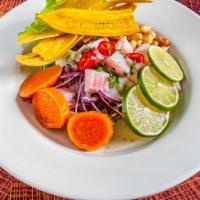 Ceviche De Pescado / Fish Ceviche · Fish marinated in lime and spices with sweet potatoes, onion, corn, and lettuce.