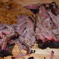 Beef Brisket · Beef brisket rubbed with dry, Jamaican herbs, spices, and slow smoked. Served with signature...