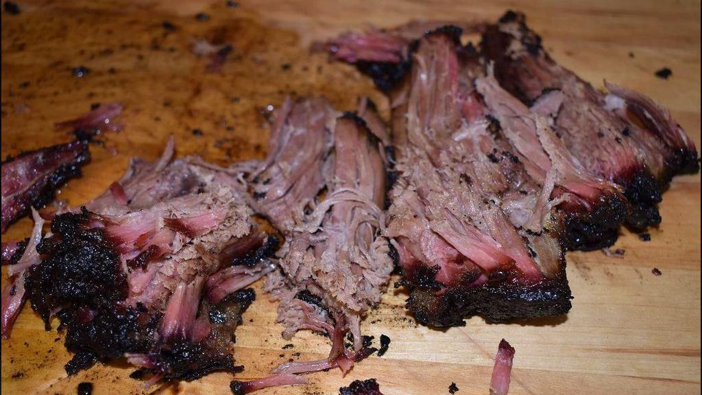 Beef Brisket · Beef brisket rubbed with dry, Jamaican herbs, spices, and slow smoked. Served with signature jerk BBQ sauce.