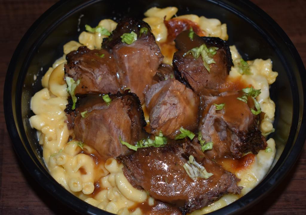 Jerk Brisket Over Mac · Jerk brisket chopped over our signature mac & cheese then drizzled with our jerk sauce