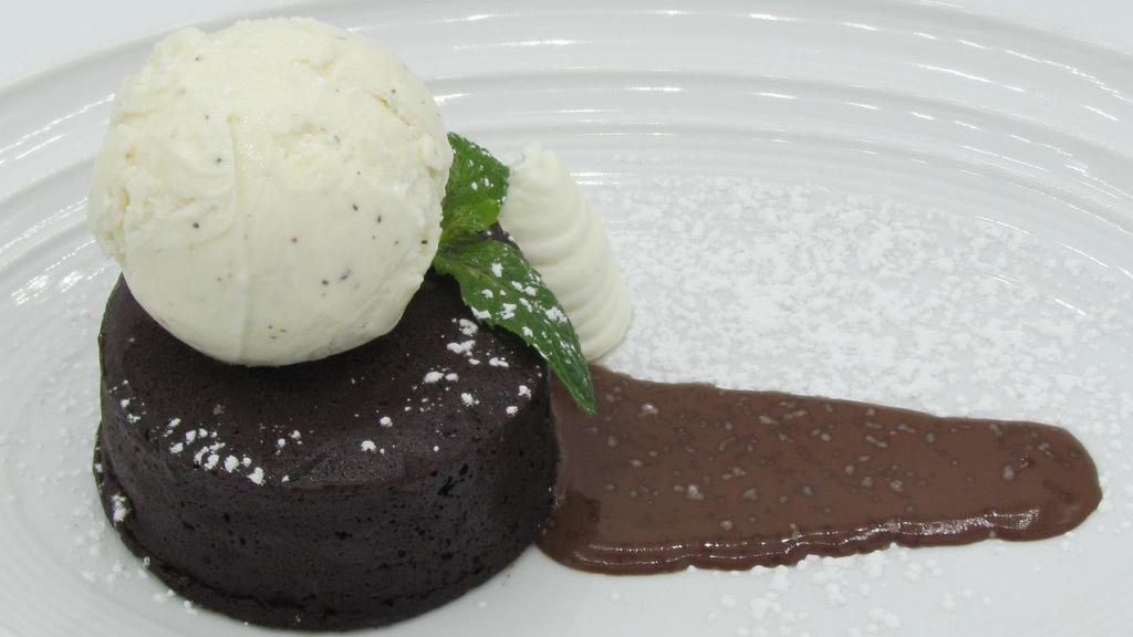 Warm Chocolate Cake · White chocolate whipped cream and Johnson's vanilla bean ice cream.