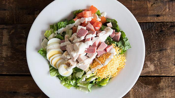 Super Chef · Crisp romaine, tomatoes, sliced egg, Cheddar, croutons, ham, turkey and lite Italian dressing or ranch dressing.