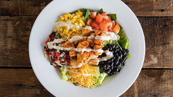 Ranchero · Crisp romaine, tomatoes, Cheddar, black beans, sweet corn, crispy tortilla chips, bbq grilled chicken, and ranch dressing.