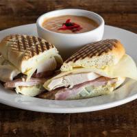 Cuban Panini · Roasted turkey and oven baked ham carved to order, pickle, Swiss, and honey dijon on a Frenc...