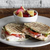 Salmon Panini · Chilled poached salmon, dill aioli, field greens, tomatoes, and red onions on flatbread. Ser...